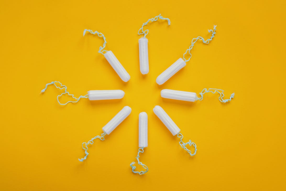 Tampons arranged in the shape of the sun on a light yellow background
