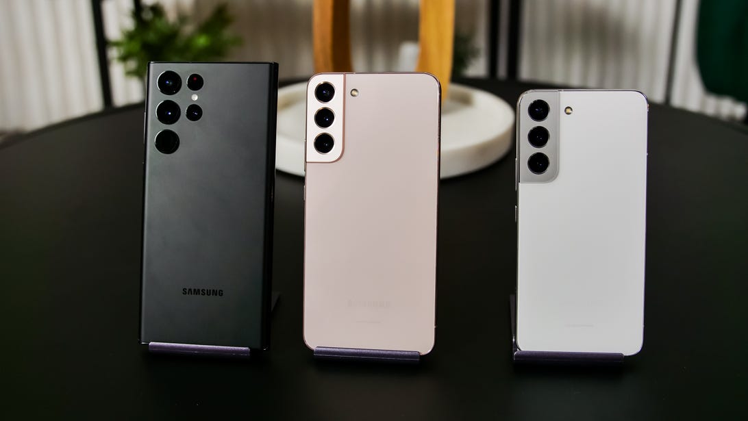 Samsung's lineup of new S22 phones on a black tabletop.