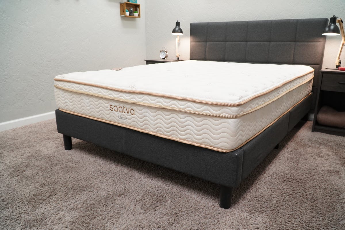 Portrait of the Saatva Classic mattress on a bed frame.