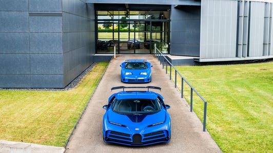 Bugatti Centodieci hypercar and Bugatti EB110 GT parked in a line outdoors