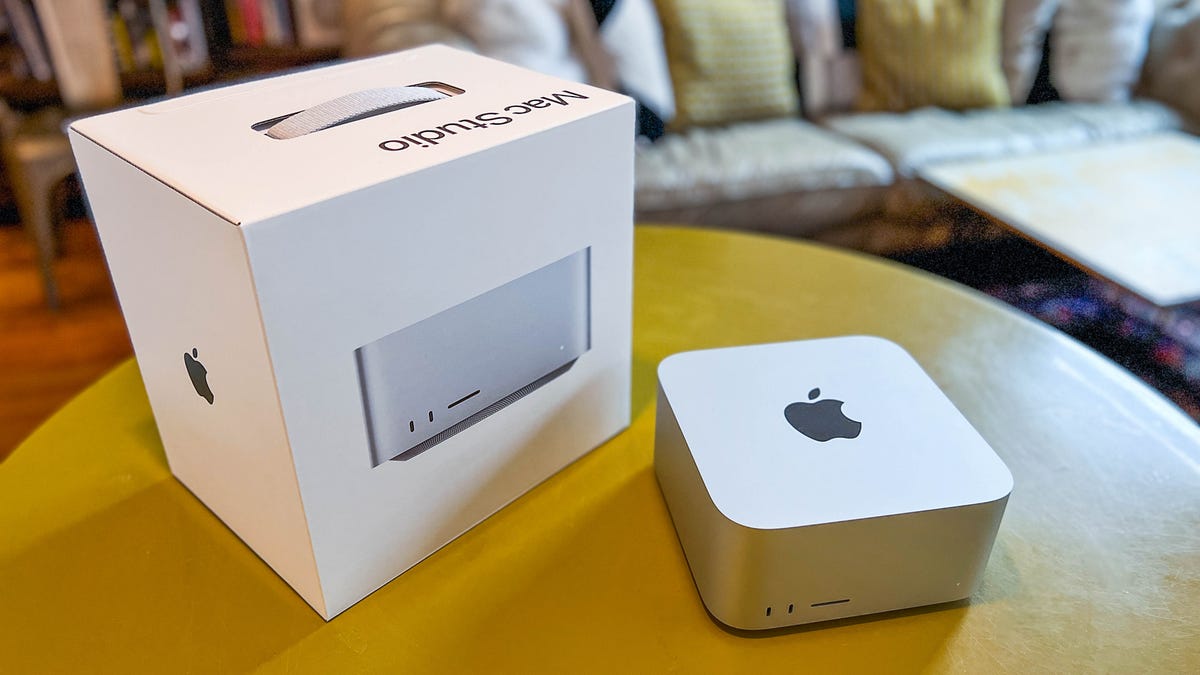 A Mac Studio Desktop and box on a wooden table.