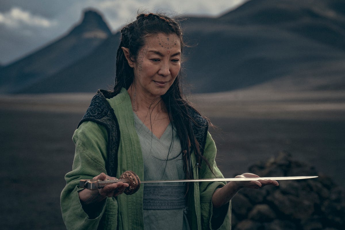 michelle yeoh as scian holding a sword in the origin of the witcher's blood
