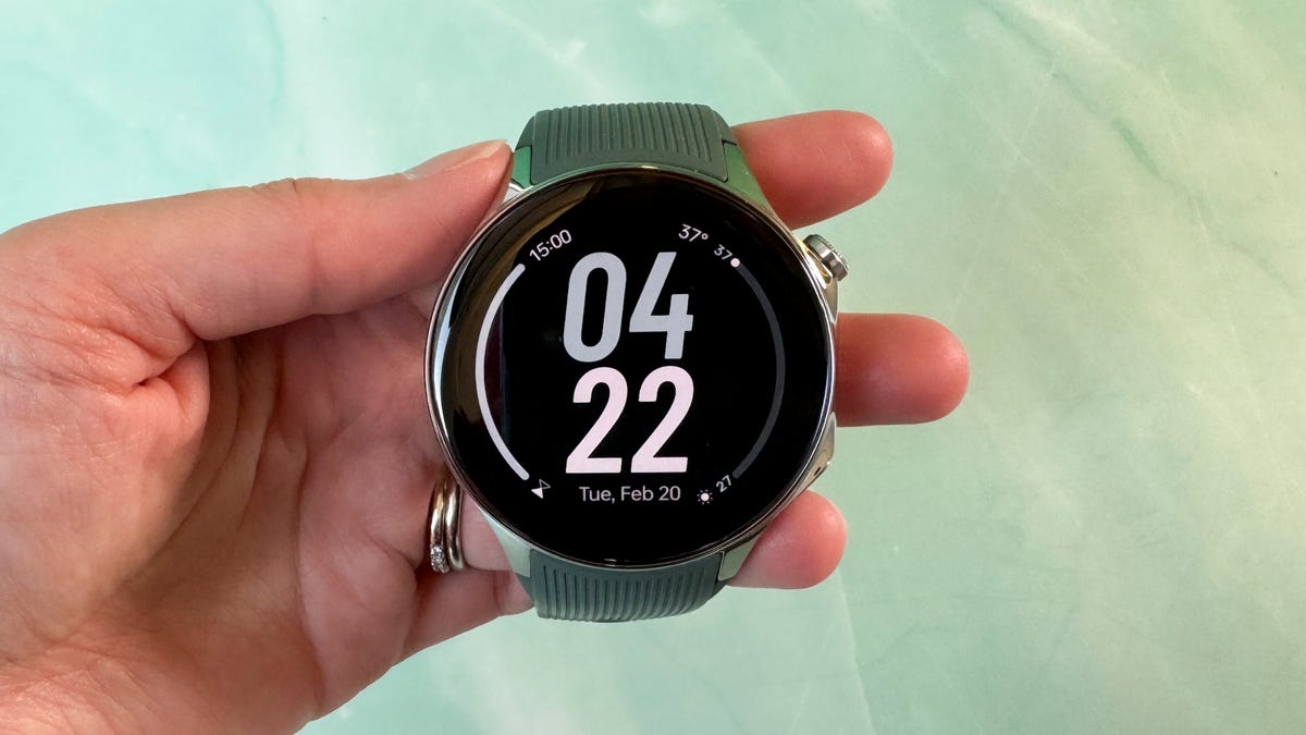 The OnePlus Watch 2 being held in someone's hand