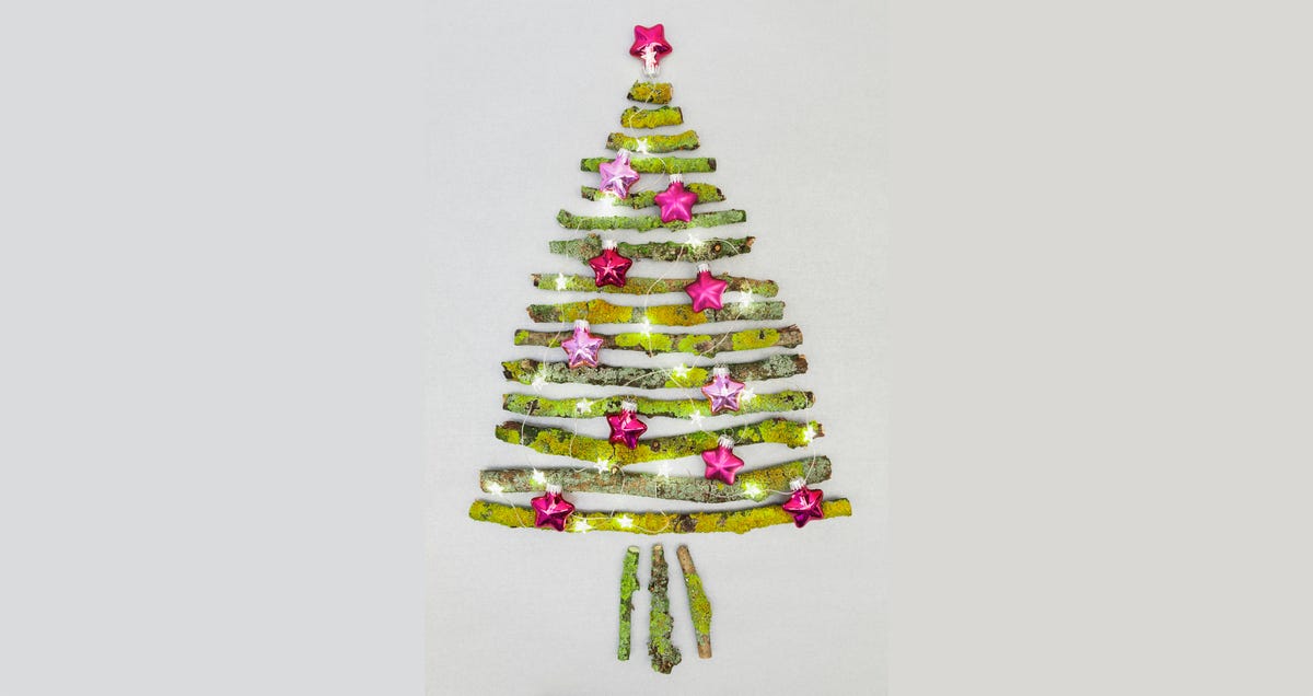 Christmas tree shaped of mossy branches and Christmas decoration