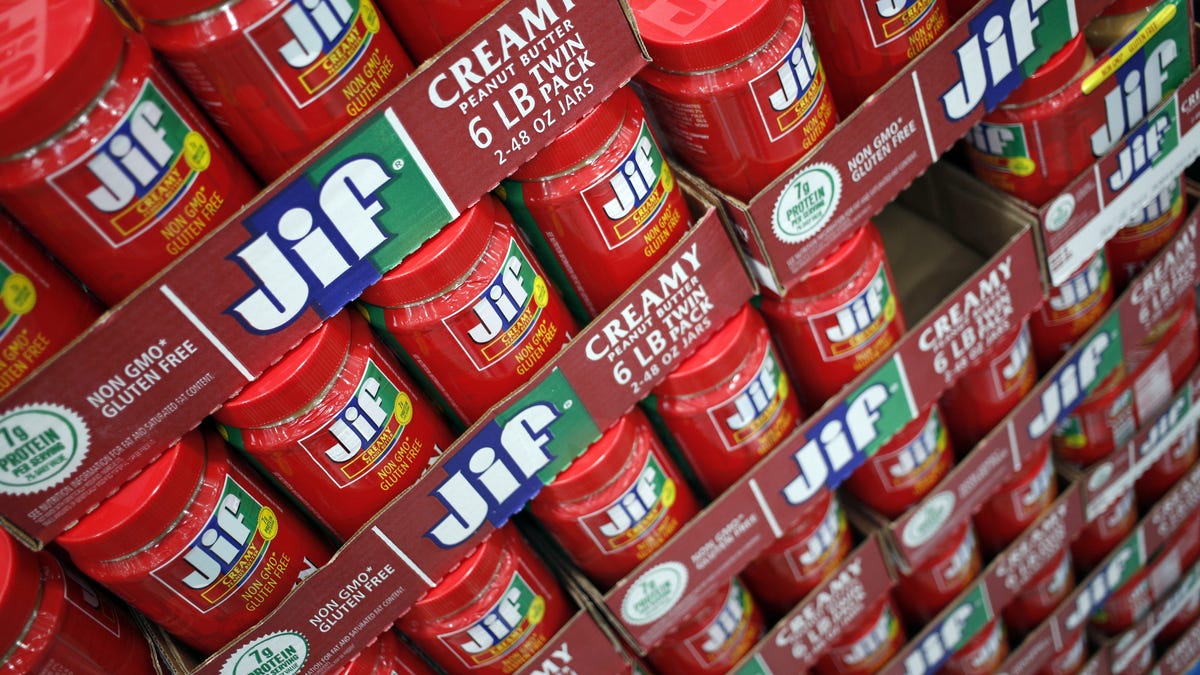 A store shelf packed with jars of Jif brand peanut butter.