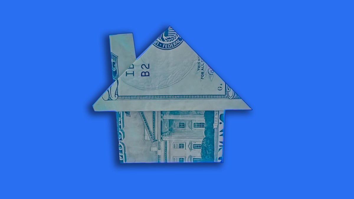 An origami house made of a 20 dollar bill