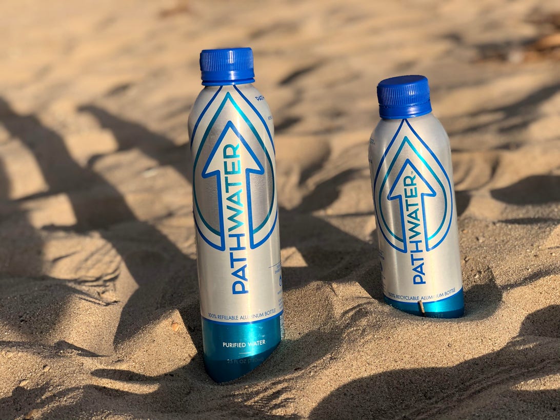 Reusable bottles in sand