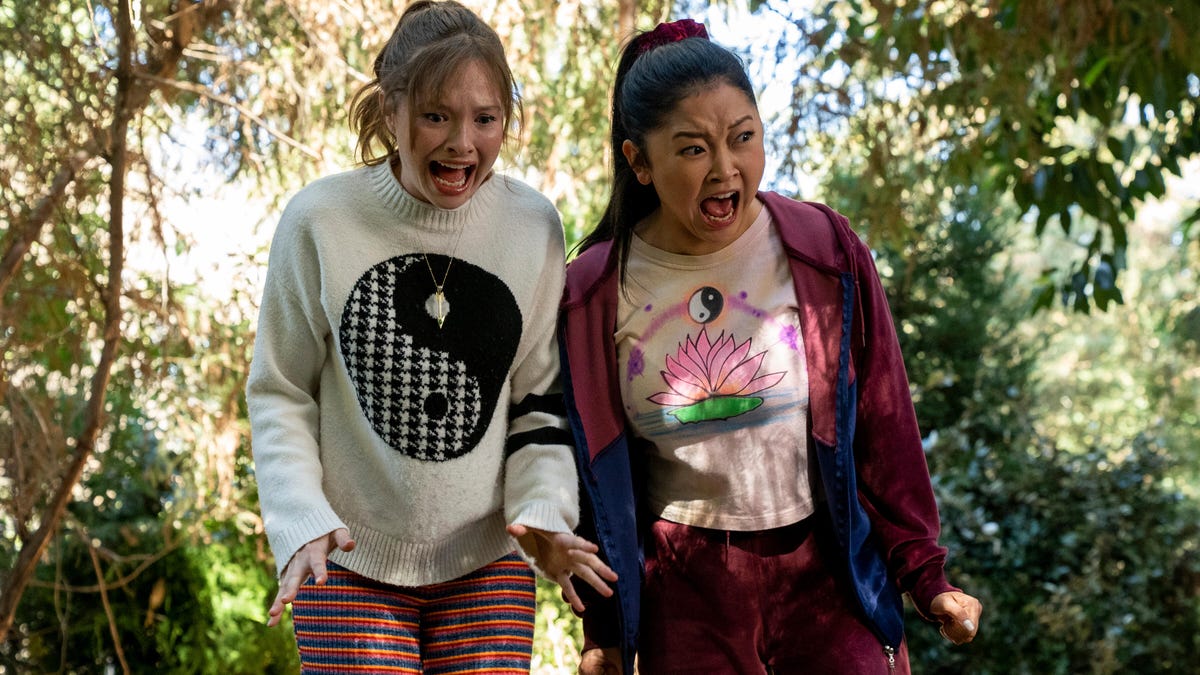 Zoe Maragret Colletti and Lana Condor screaming at something in the woods.