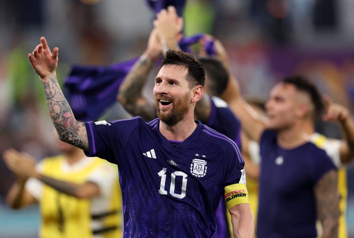 Lionel Messi of Argentina raises his hand in celebration after a victory.