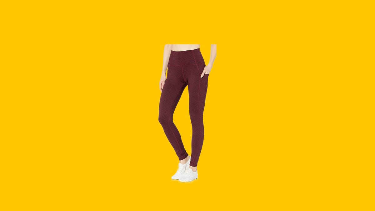 A woman in a pair of red leggings on a yellow background