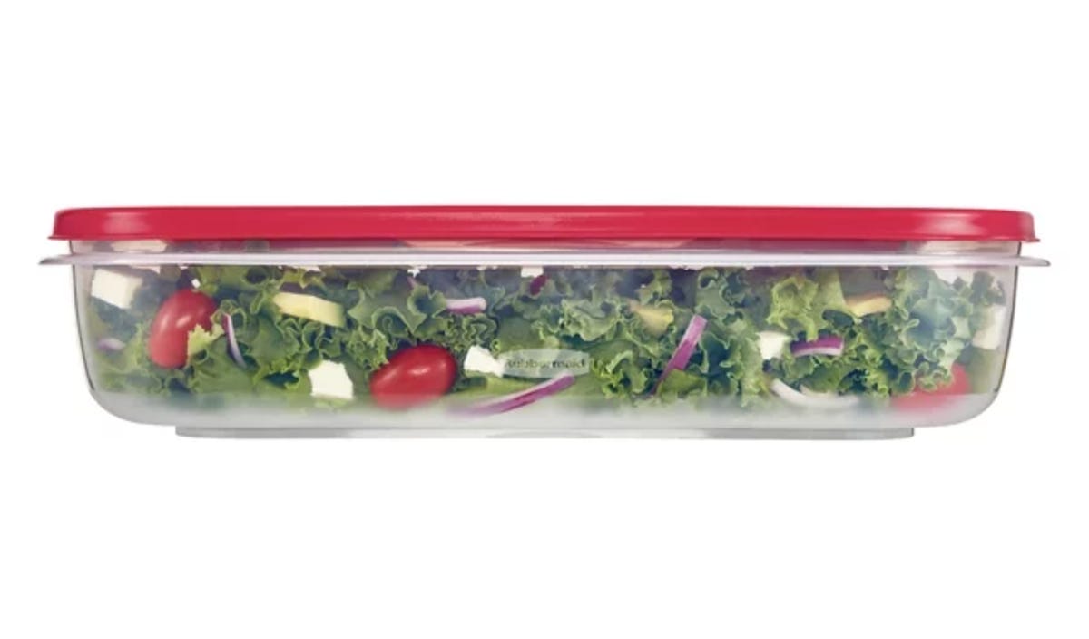 plastic container with salad greens inside