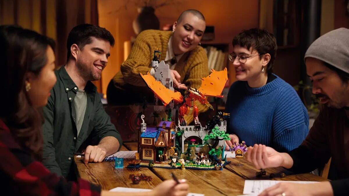 5 friends sitting around a Lego Dragon set