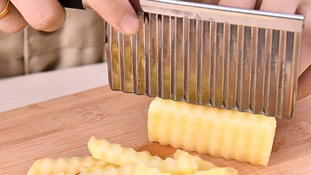 Knife making crinkle cut in potato