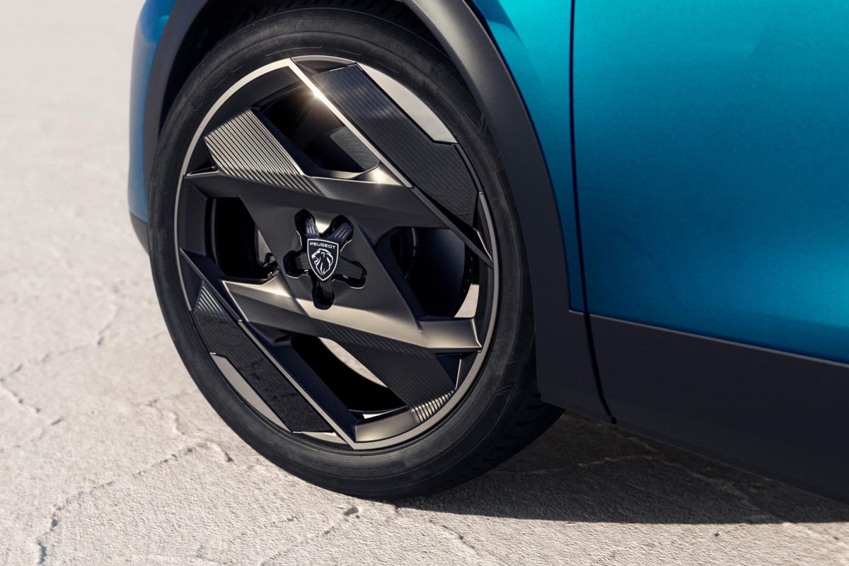 Close-up shot of a blue Peugeot 408 crossover's wheels