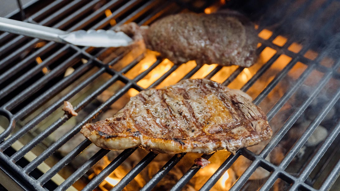 Steaks connected  a grill 