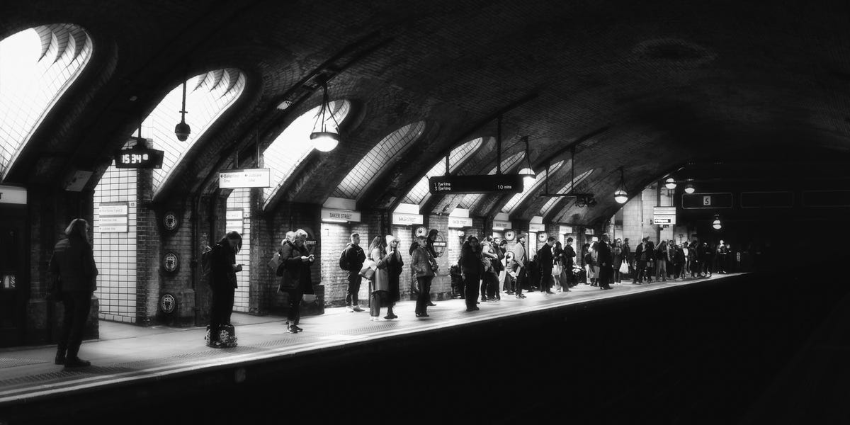 A photo of a London tube platform in black and white
