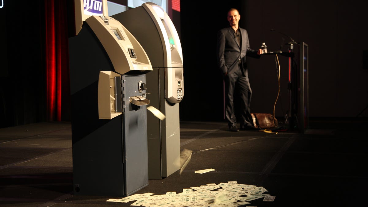 Security researcher Barnaby Jack demonstrates how he bypassed the security of two ATMs.