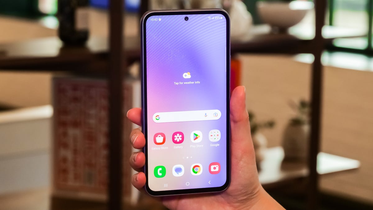 Samsung's Galaxy A54 5G being held with the screen showing