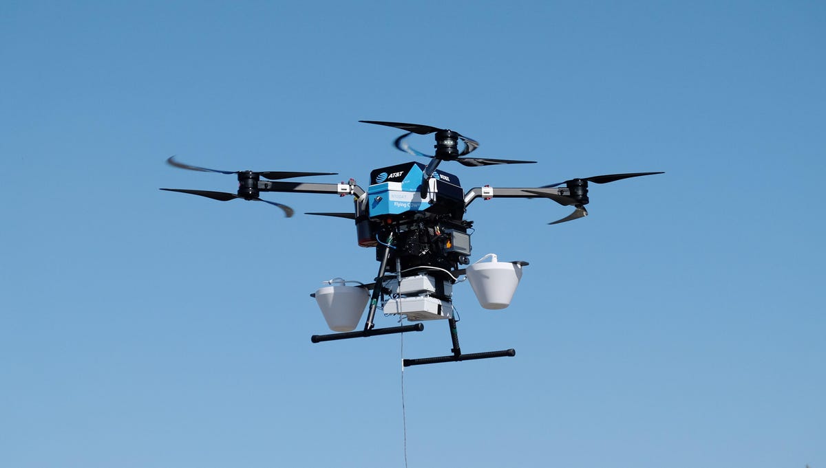 An AT&T Flying COW drone with 5G network equipment flies in a blue sky