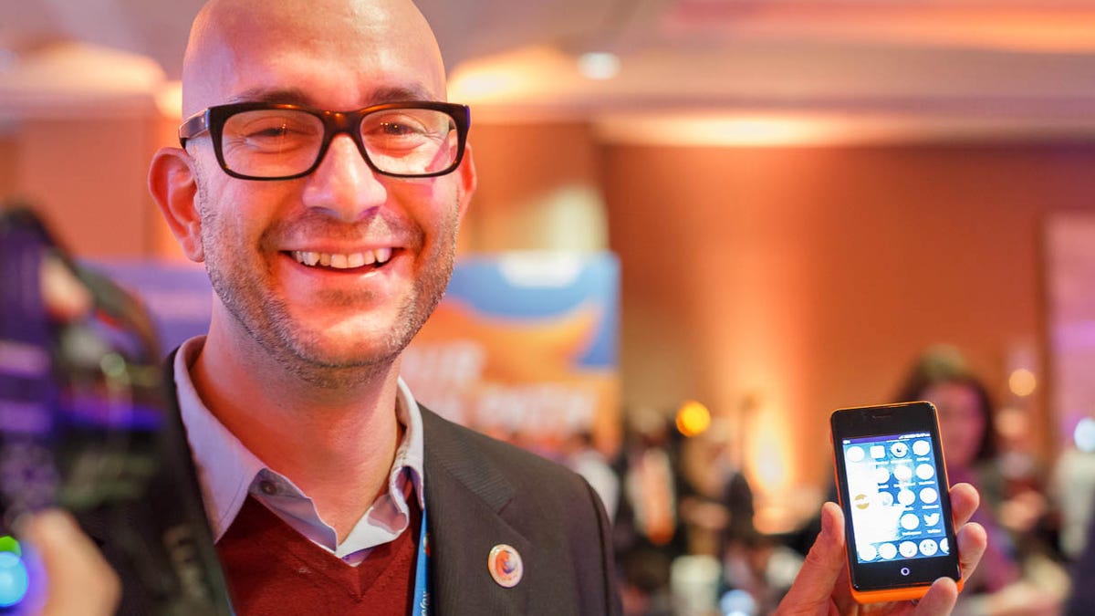 Carlos Domingo, Telefonica Digital's director of product development and innovation, holds a Geeksphone Keon Firefox OS phone.