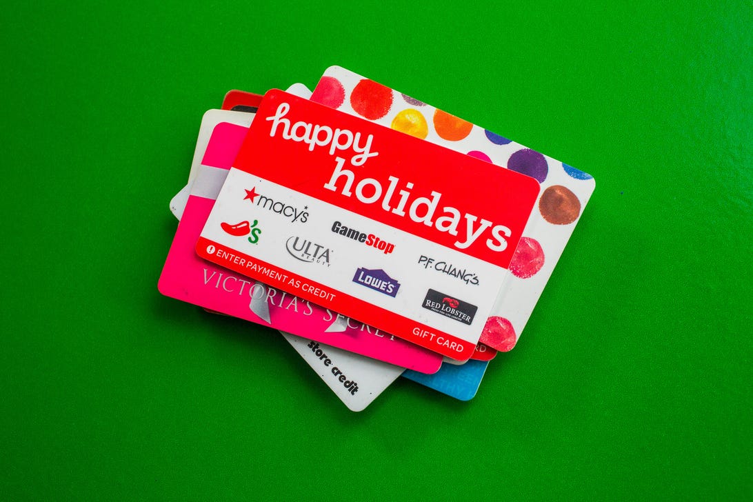 A stack of gift cards, the top one saying "happy holidays"