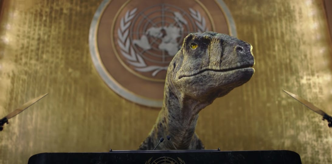 CGI dinosaur speaks at the podium in a UN video