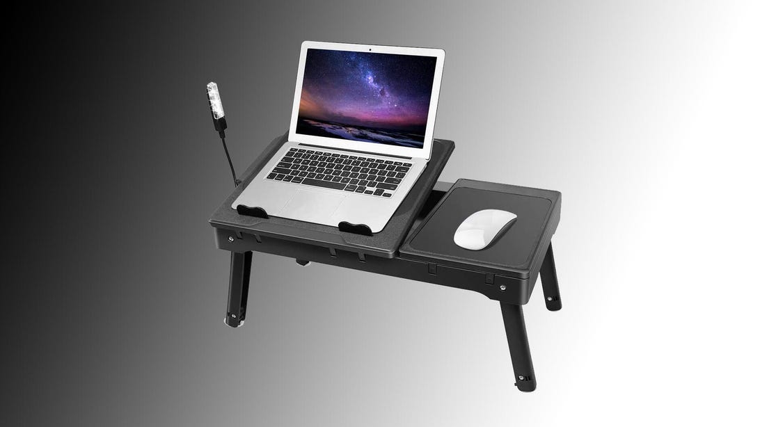 This  laptop stand has a built-in reading lamp, cooling fan and USB hub