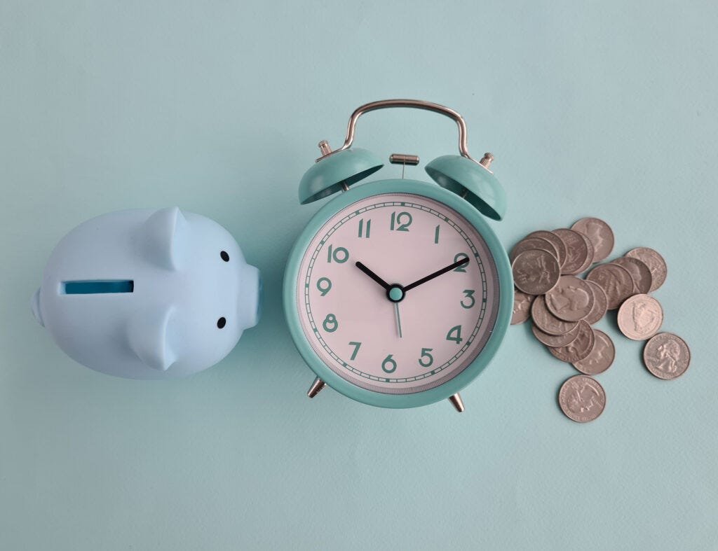 Piggy bank, alarm clock and coins.